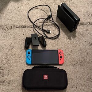 Nintendo Switch OLED with Red and Blue Joy-Con Controllers and dock